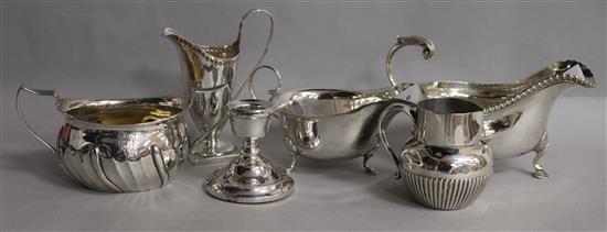 A demi fluted silver cream jug, a 1930s silver sparrow beak jug, two silver sauceboats, a silver sugar bowl & a candlestick